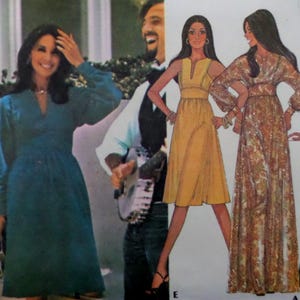 May include: A sewing pattern envelope featuring a teal long-sleeved dress, a yellow knee-length dress with a V-neckline, and a long-sleeved floor-length dress with a brown and orange paisley print. The cover includes illustrations of the garments.