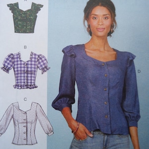 May include: Image of a sewing pattern featuring four blouse designs. The blouses include a green floral print, a purple gingham, a white dotted, and a blue denim style with a square neckline and button-up front.