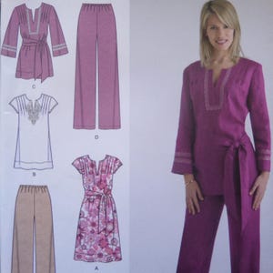 May include: A sewing pattern envelope featuring illustrations of a tunic with long sleeves, a short-sleeved tunic, wide-leg pants, and a floral dress. The cover displays a person wearing a solid magenta long-sleeved tunic with a tie waist and pants.