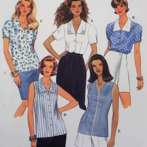 May include: A sewing pattern illustration featuring five different blouse designs labeled A through E. The tops include various styles such as short-sleeved button-downs with collars, sleeveless striped shirts, and solid-colored blouses with trim.