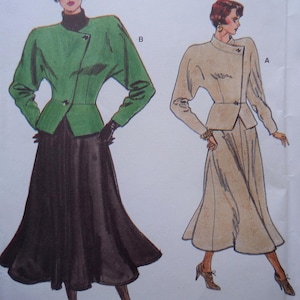 May include: Illustration of two women's outfits. One outfit is a green jacket with a black skirt. The other outfit is a beige jacket and skirt. Both outfits have a similar design, with a fitted waist and flared skirt.