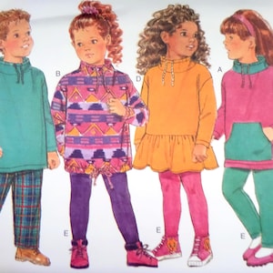 May include: A sewing pattern illustration featuring four outfits: a teal pullover with plaid pants, a purple and pink geometric print pullover with leggings, an orange drop-waist tunic with leggings, and a pink pullover with a teal pocket and leggings.