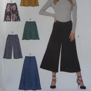 May include: A fashion illustration featuring various garment designs. The image showcases a woman wearing wide-leg black pants. Other designs include a floral print skirt, a green skirt, a denim skirt, and gray wide-leg pants. The garments are presented as sewing patterns.