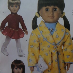 May include: A doll wearing a yellow robe with blue stars and trim, holding a white stuffed animal. Another doll is wearing a red skating outfit with a gold trim and white ice skates. The image is a pattern for dolls.