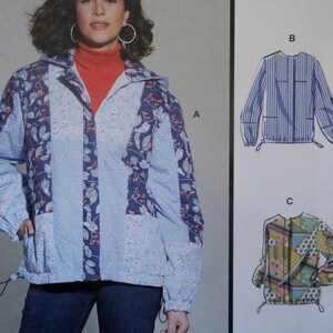 May include: A light blue jacket with a floral pattern and a drawstring waist. The jacket has a hood and pockets. The model is wearing a red turtleneck underneath. The image also shows two additional jacket designs.