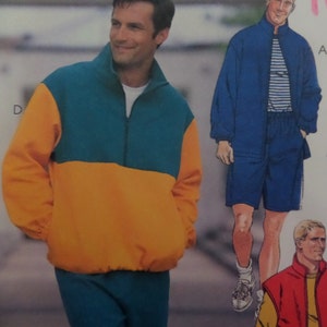 May include: A color-blocked teal and yellow fleece pullover with a quarter-zip closure. The image also shows a blue jacket and shorts set, and a red and yellow vest.