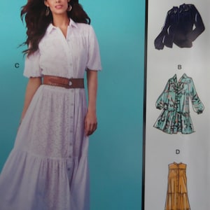 May include: A white eyelet dress with short sleeves and a button-down front, cinched at the waist with a brown belt. The dress has a tiered skirt. Additional garment designs are shown on the right side of the image.
