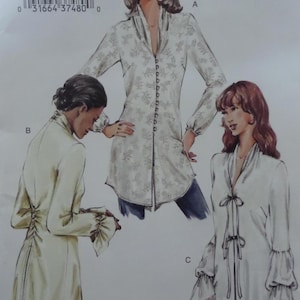 May include: A sewing pattern featuring three different long-sleeve tunic designs. The tunics are shown in various styles, including a button-down front, a high-neck design with a laced back, and a tunic with a tie-front and bell sleeves. The pattern includes a barcode.
