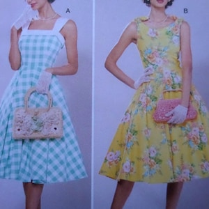 May include: Two vintage-style dresses. One is a light blue and white gingham pattern with a square neckline and a matching handbag. The other is yellow with a floral print, a round neckline, and a pink handbag. Both dresses have a flared skirt.