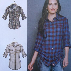 May include: A sewing pattern illustration featuring three shirt variations. Style A shows a paisley print shirt. Style B is a blue and maroon plaid button-down shirt with side ruching. Style C displays a solid light-colored shirt with visible stitching.
