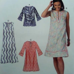 May include: A set of three ceramic mugs with a speckled, cream-colored glaze. Each mug features a different hand-painted floral design in shades of blue, green, and yellow. The mugs have a simple, rounded shape and a comfortable handle.