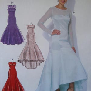 May include: A sewing pattern illustration featuring four floor-length dresses labeled A, B, C, and D. Dress A is red, dress C is a patterned beige, and dress D is purple with lace. Dress B is a light blue gown with long sheer sleeves and a high neckline.
