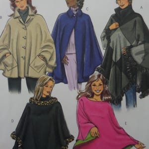 May include: A sewing pattern illustration featuring five different cape designs. The styles include a beige button-front cape with pockets, a solid blue cape, a black and gray geometric patterned cape with fringe, a black cape with leopard print trim, and a pink cape.