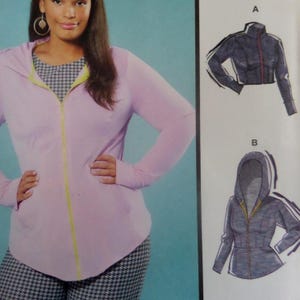May include: A light purple zip-up hoodie with a yellow zipper and trim, worn over a black and white houndstooth patterned top. To the right, two technical sketches labeled A and B show a dark blue jacket with a zipper and a hooded jacket design.
