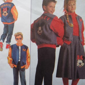 May include: Children's clothing set featuring Mickey and Minnie Mouse designs. The set includes a blue and gold jacket with the letter "M", a gray jacket with "Mickey" on the back, and a gray skirt with a Minnie Mouse applique. The outfits are paired with red tops.