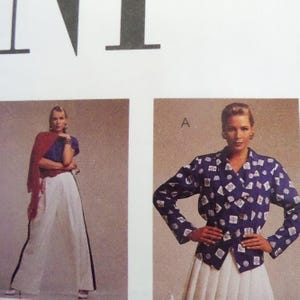 May include: Image of a fashion magazine page featuring two women modeling clothing. One woman wears a blue top, white pants with a black stripe, and a red shawl. The other wears a blue patterned jacket and a white skirt.