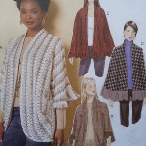 May include: A sewing pattern envelope featuring four variations of an open-front cardigan or cape. The designs include a cream-colored textured knit, a solid rust-colored piece, a brown knit, and a black and white houndstooth pattern with ruffles.