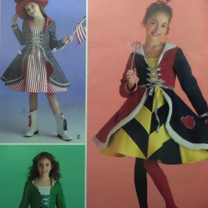 May include: A sewing pattern envelope featuring three costume designs: a patriotic outfit with a star-spangled coat and striped dress, a playing card-inspired dress with heart motifs, and a green jacket over a patterned dress with a white top.