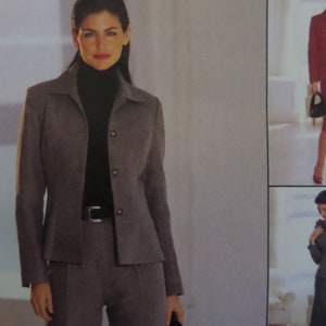 May include: A gray blazer with a collared neckline and three front buttons, worn over a black turtleneck sweater and paired with matching gray trousers featuring a black belt. The ensemble is shown in a multi-view clothing catalog layout.