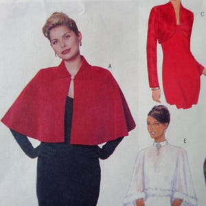 May include: A sewing pattern illustration featuring three garments: a red cape with a single button closure labeled A, a red long-sleeved bolero jacket over a matching dress labeled C, and a white sheer capelet with a high collar labeled E.