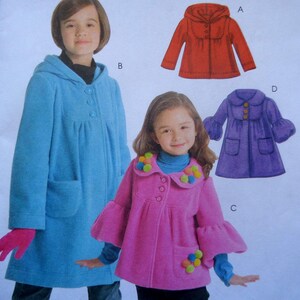 May include: Image of a pattern for children's coats. The coats are in various colors, including red, blue, and purple. The coats have different styles, such as hooded and flared sleeves. The pink coat has pom-pom accents.