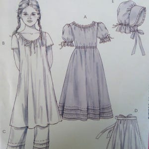 May include: Illustration of a young girl and several clothing items. The items include a dress with puffed sleeves, a nightgown with a bow, pants, a bonnet, and a skirt. All items are light blue.