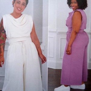 May include: Two women wearing matching sets. One set is white, featuring a cowl neck top and wide-leg pants with a drawstring waist. The other set is lavender, with a sleeveless top and wide-leg pants. Both outfits are paired with white sneakers.