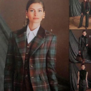 May include: A plaid blazer and matching vest in shades of dark green, brown, and red, worn over a crisp white collared shirt. The blazer features a dark brown collar, notched lapels, and a button-front closure. The letter B is visible nearby.
