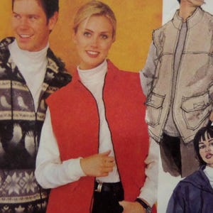 May include: A sewing pattern illustration featuring a red sleeveless vest with a front zipper, a white turtleneck shirt, a patterned zip-up jacket with a hood, and a beige vest with large front pockets and a high collar over a white shirt.