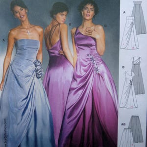 May include: Three elegant evening gowns in shades of blue and purple. The gowns feature draped fabric, asymmetrical designs, and floral embellishments. The image also includes dress pattern illustrations.