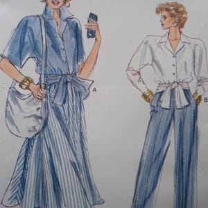 May include: Illustration of two women's fashion designs. One figure wears a blue short-sleeved shirt and a striped skirt with a bow. The other figure wears a white long-sleeved shirt and striped pants, also with a bow.