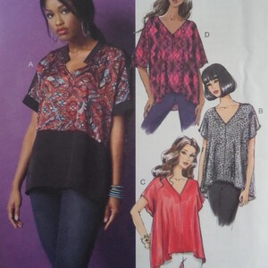 May include: A sewing pattern envelope featuring a V-neck top with short sleeves. The design includes a color-blocked version with a red, black, and blue patterned upper section and solid black lower section, alongside illustrations of variations.