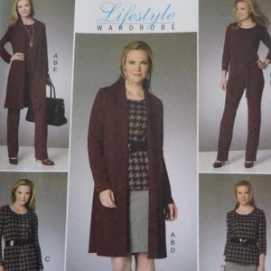 May include: A sewing pattern envelope titled Lifestyle Wardrobe featuring illustrations of clothing sets including long cardigans, trousers, skirts, and tops in solid dark maroon and houndstooth patterns, with labels A, B, C, and D visible.