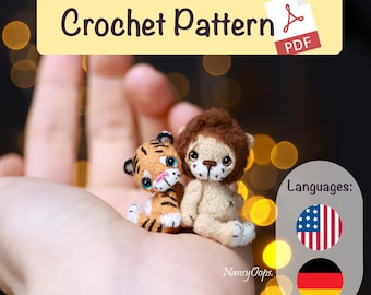Op de afbeelding: Een PDF-haakpatroon met de tekst "Crochet Pattern" en twee kleine amigurumi's: een tijger en een leeuw. De tijger is oranje en zwart, de leeuw is beige met een bruine manen. De afbeelding bevat ook de Amerikaanse en Duitse vlag.