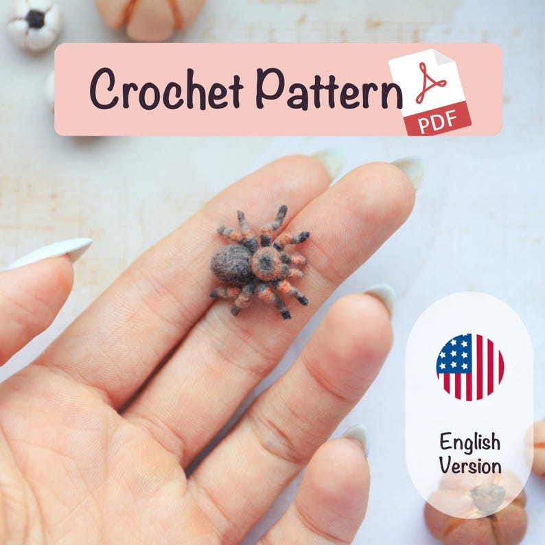 May include: A crocheted spider with a gray body and orange legs is held in a hand. The image includes a banner that reads "Crochet Pattern" and a PDF icon. An American flag icon with the words "English Version" is also present.