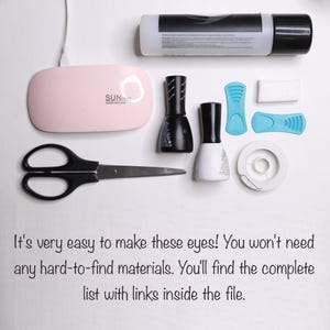 May include: A collection of nail art supplies, including black and white nail polish bottles, a pink UV LED nail lamp, scissors, and blue nail art tools. The image includes text that reads, "It's very easy to make these eyes!"