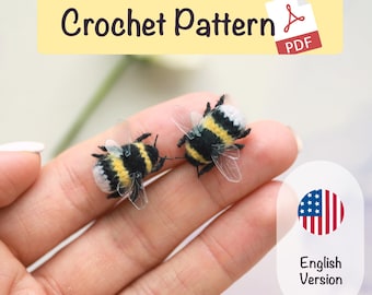 May include: Two handmade crochet bees with black, yellow, and white details, held in a hand. The bees have transparent wings. The image includes text that says "Crochet Pattern PDF" and "English Version".