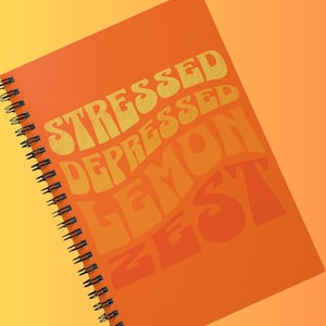 May include: Orange spiral-bound notebook with the words "STRESSED DEPRESSED LEMON ZEST" in a retro font. The notebook has a black spiral binding and is set against a gradient orange background.
