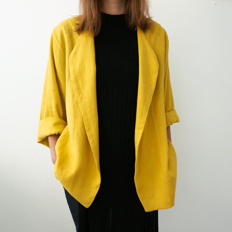 May include: A yellow linen blazer with a long, open front and a relaxed fit.