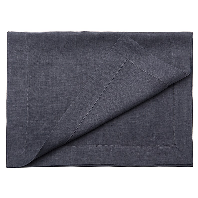 May include: A dark gray linen placemat with a stitched border. The placemat is folded in half, showing the underside.