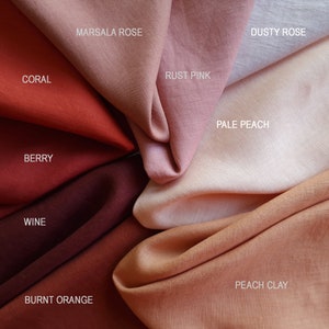 May include: A collection of fabric swatches in various shades of red, orange, and pink. The swatches are labeled with names like "Coral", "Berry", "Wine", "Marsala Rose", "Rust Pink", "Dusty Rose", "Pale Peach", "Peach Clay", and "Burnt Orange".