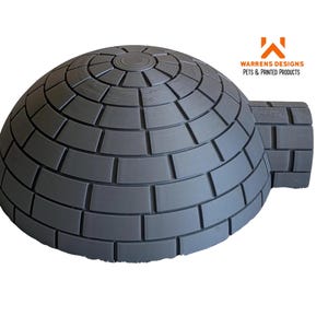 May include: A grey, igloo-shaped pet house with a circular top and a rectangular entrance. The structure is made of rectangular blocks. The logo "WARRENS DESIGNS PETS & PRINTED PRODUCTS" is in the upper right corner.