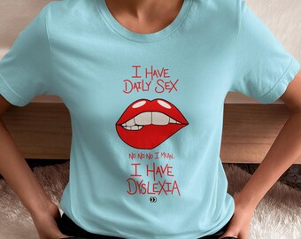 May include: Light blue t-shirt with the text "I HAVE DAILY SEX" above a red cartoon mouth biting its lip. Below the mouth, the text reads "NO NO NO I MEAN. I HAVE DYSLEXIA."