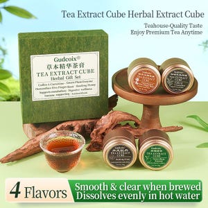 May include: A tea extract cube gift set with four flavors, including Coffee L. Carnitine and Green Plum Enzyme. The set includes a green box, small tea tins, and a glass teacup. The text on the box reads "Tea Extract Cube Herbal Gift Set."