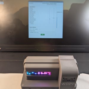 May include: A white ceramic mug with a black handle and the text "But First, Coffee" in a bold, black font. The mug is set against a blurred background, suggesting a cozy setting.