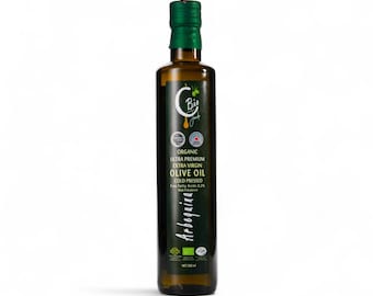 May include: A dark glass bottle of organic, ultra-premium extra virgin olive oil. The bottle has a green cap and a label with the text "Bi", "Olive Oil", and "Arbequina". The bottle contains 500 ml of olive oil.