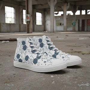 May include: White high-top sneakers with a repeating pattern of blue hexagons and circuit board lines. The shoes have white laces and a white rubber sole. The sneakers are in a warehouse setting.