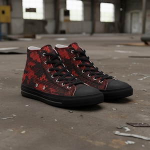 May include: A pair of high-top sneakers with a red and black pixelated pattern. The shoes have black laces, a black toe cap, and a black sole. The sneakers are made of canvas material.