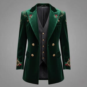May include: A dark green velvet blazer with gold buttons and embroidered floral details. The blazer has a matching vest underneath. The embroidery includes red and gold accents. The blazer is a long coat style.