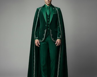 May include: A formal green velvet suit with a matching cape. The suit includes a jacket, vest, and pants. The cape and jacket are trimmed with a silver embroidered design. The outfit is completed with a green tie and dress shoes.